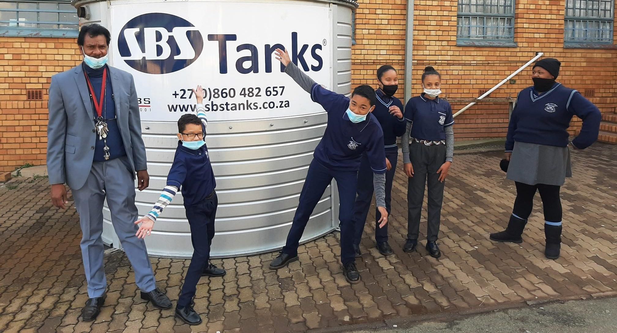 Bernard Isaacs Principal Danny Reddy and learners are excited about their new SBS water tank e1630672787845